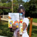 Woman holding the Life Aligned Mindful Coloring Set with affirmations and colored pencils
