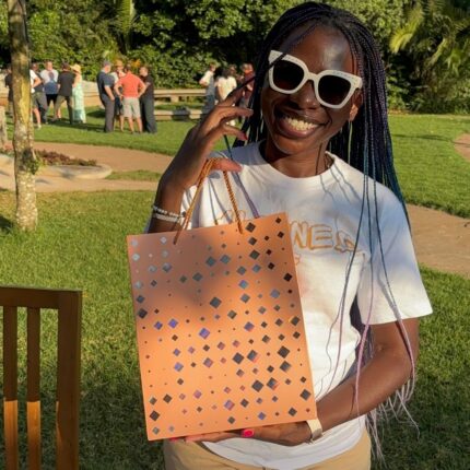 A customer holding the Life Aligned gift bag after purchase