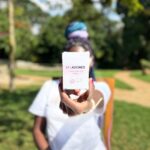 Woman holding Life Aligned Conversation Cards box