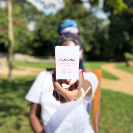 Woman holding Life Aligned Conversation Cards box