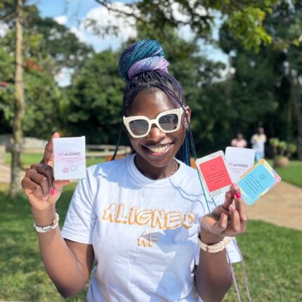 Woman holding Life Aligned Conversation Cards and box