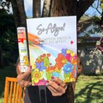 Close-up of hands holding the Mindful Coloring Set against a neutral background