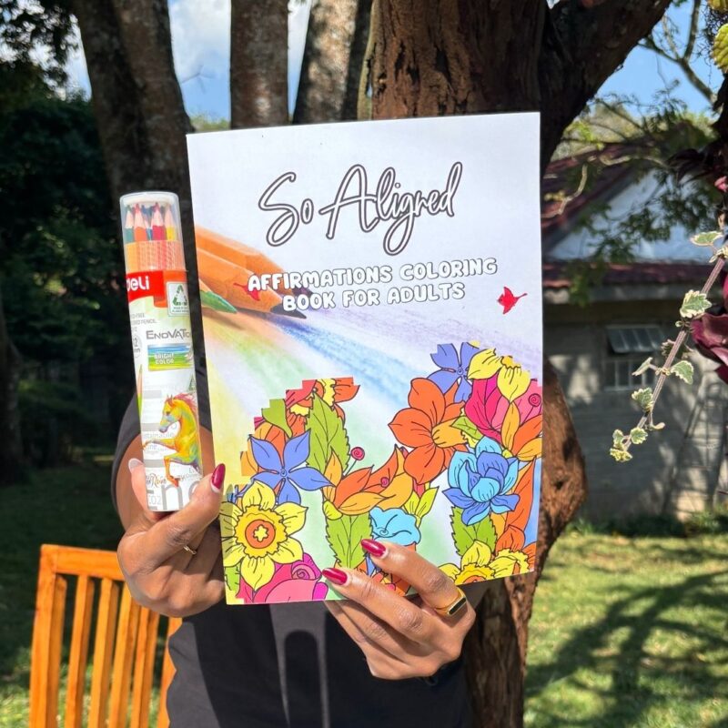 Close-up of hands holding the Mindful Coloring Set against a neutral background