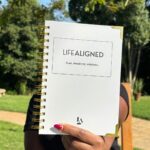 Woman holding the Grey Life Aligned Planner