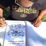 Woman coloring through coloring book pages