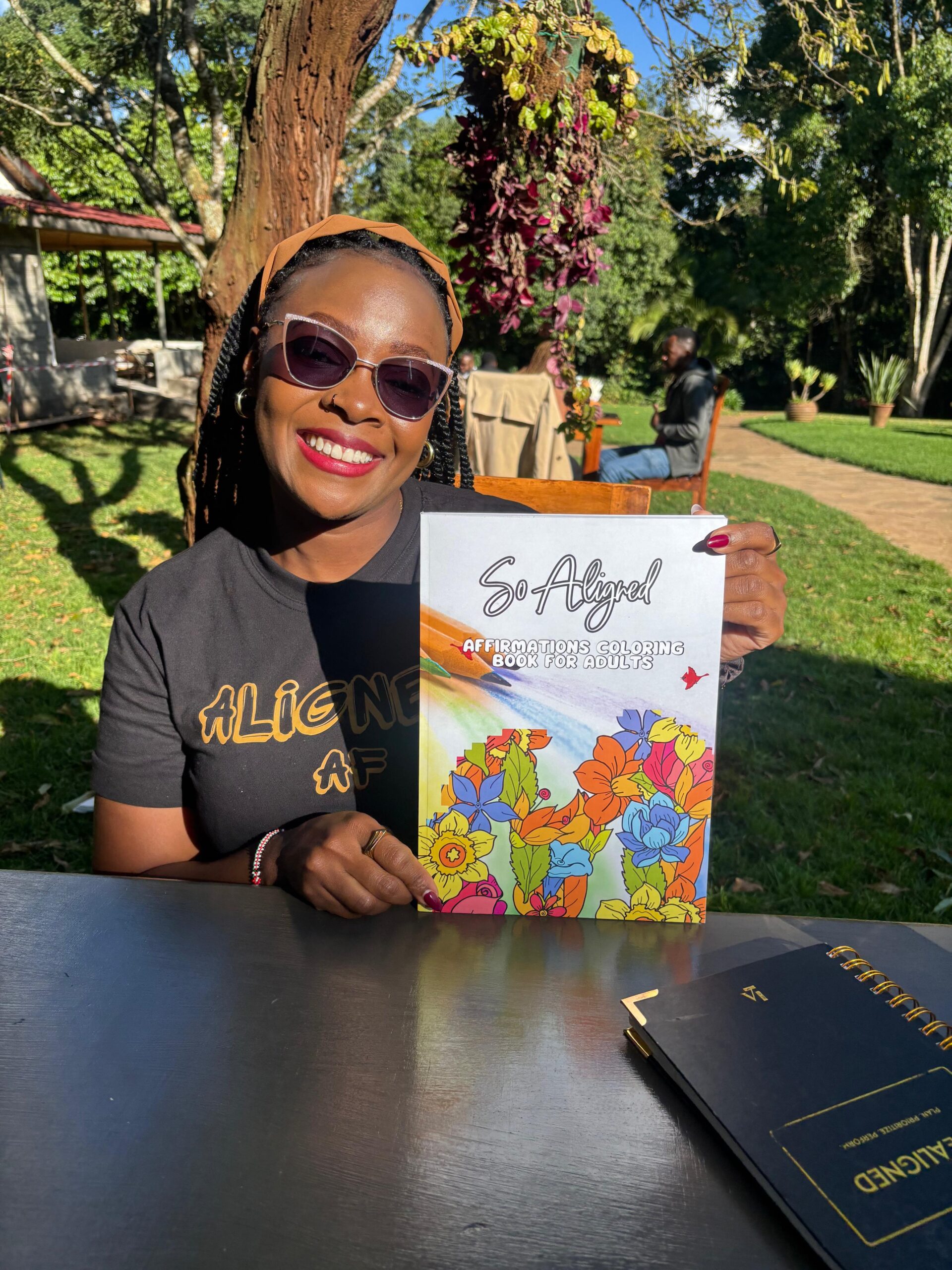 Life Aligned Coloring Book – Self-Care & Mindfulness Woman holding Life Aligned Affirmations Coloring Book