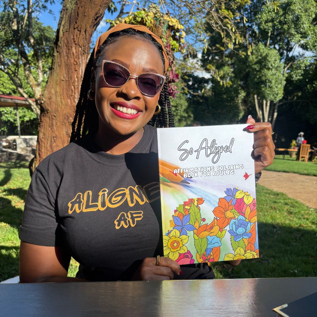 Woman holding the "So Aligned" Adult coloring book.