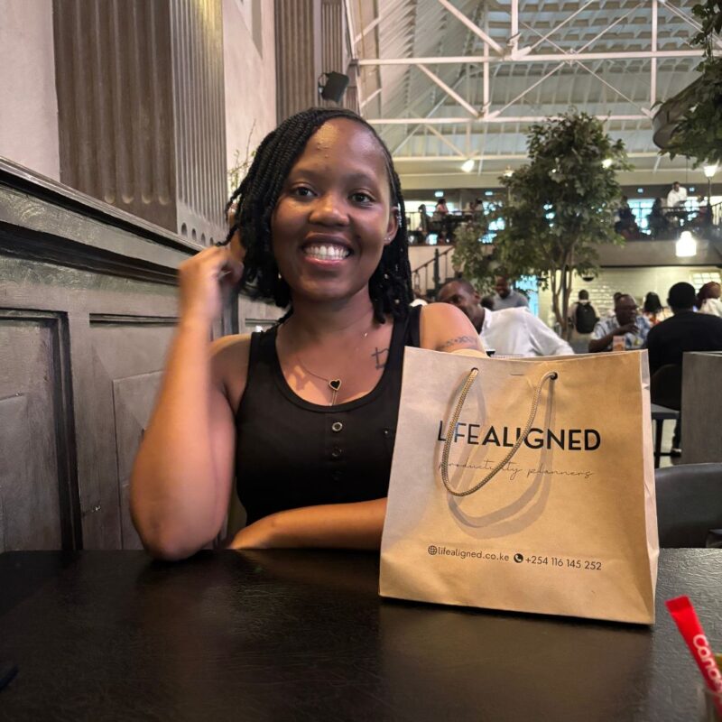 Smiling customer with Life Aligned parcel