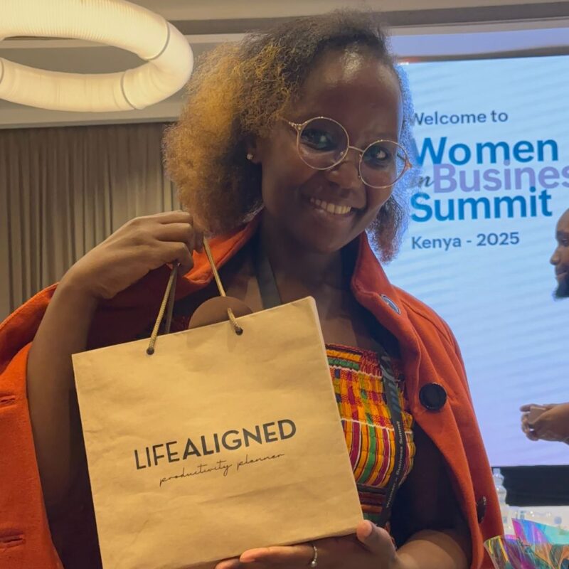 Customer holding black Life Aligned Planner package