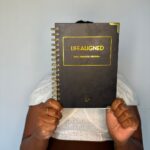 Customer holding black Life Aligned Planner