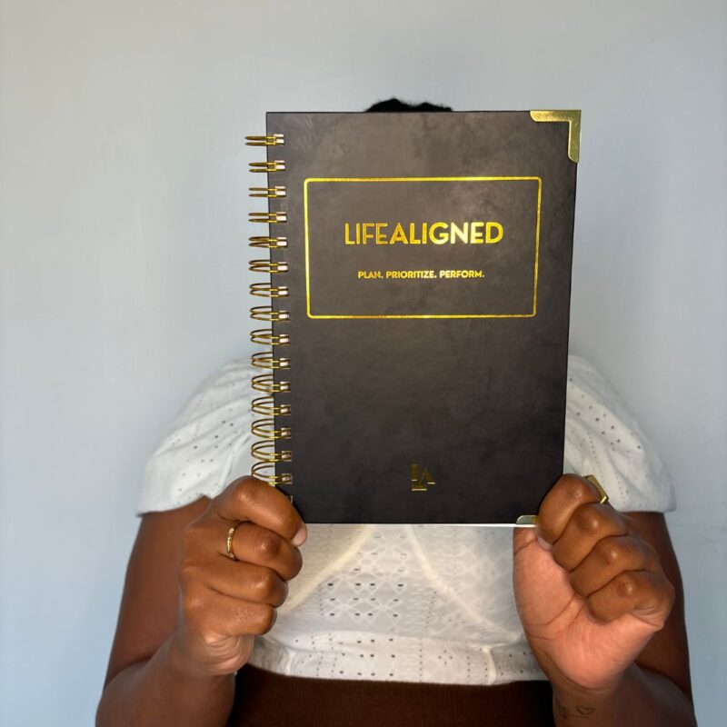 Customer holding black Life Aligned Planner