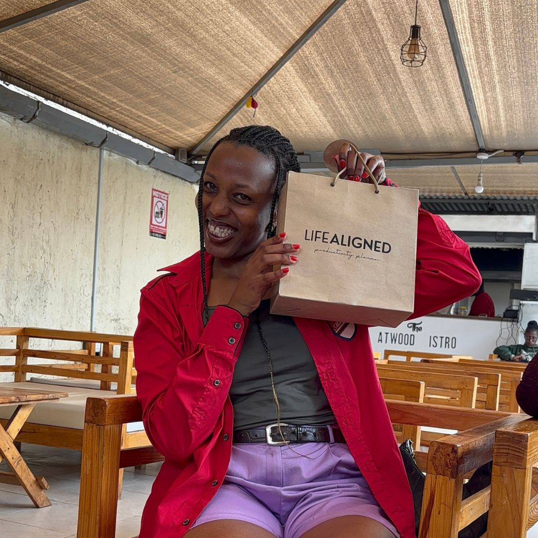 Life Aligned team member smiling with Life Aligned package